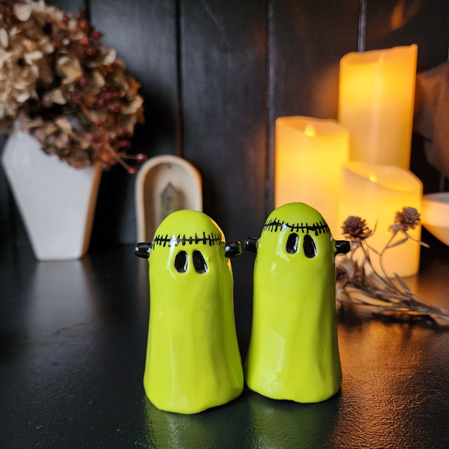 2 lime green frankenstein ghosts. With stitches around head and screws on the sides